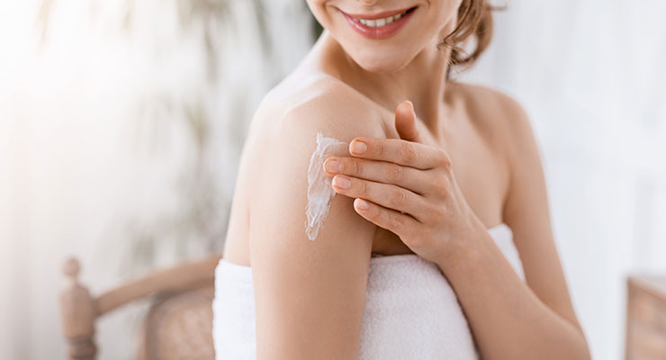 Skincare oil and botanical ingredients in soft natural light